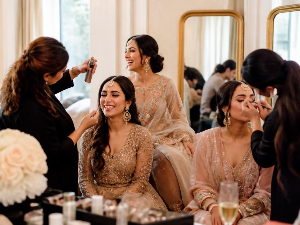 Group of women getting ready together with makeup artists