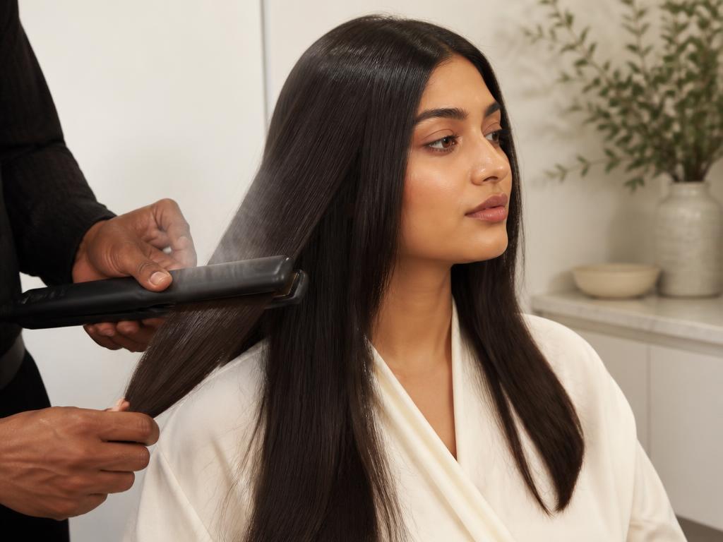 Hair being smoothed with a flat iron